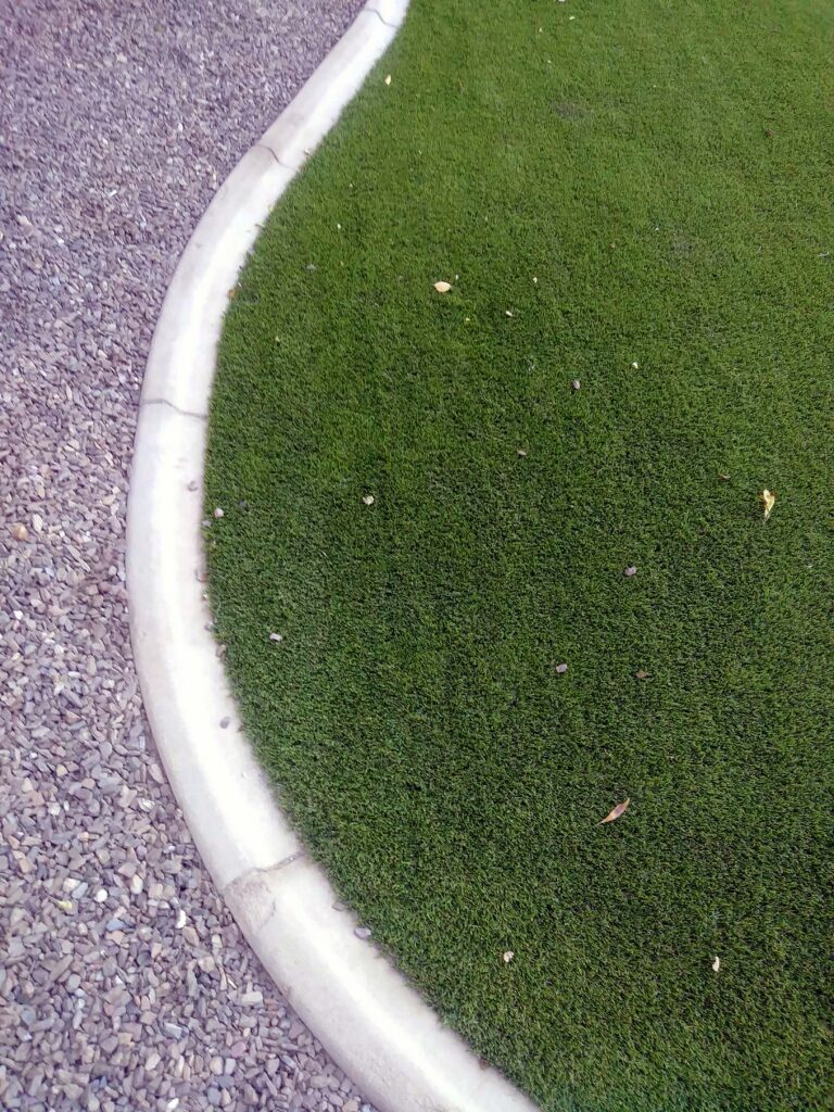artificial grass with white mower style curbing and gravel