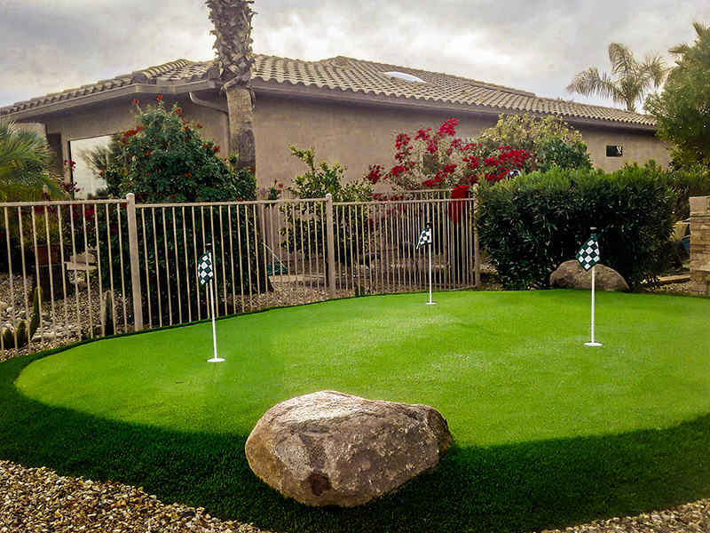 Putting green in HOA community with decorative rock and gravel