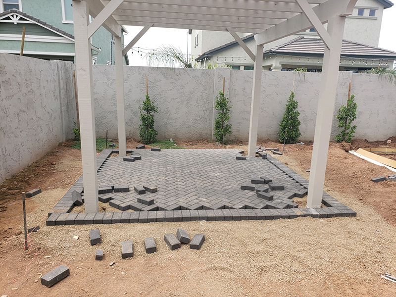 pergola being installed with pavers