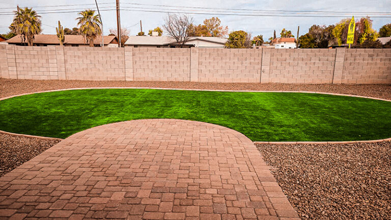 Backyard pavers with artificial grass curbing and gravel