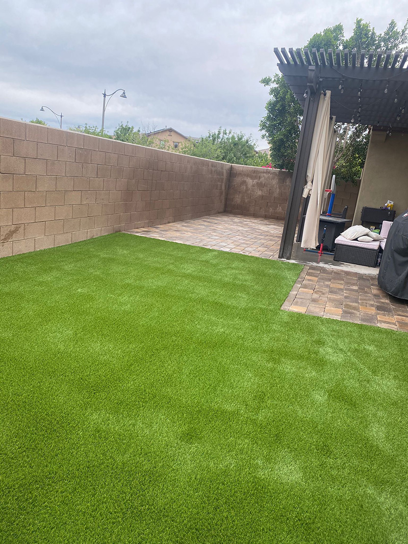 large artificial turf area with brow pergola