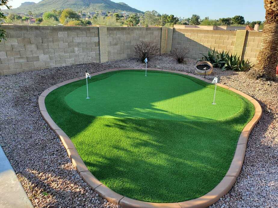 Backyard custom putting green with curbing and large fringe area